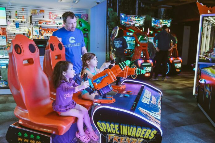 a man and a little girl playing a video game